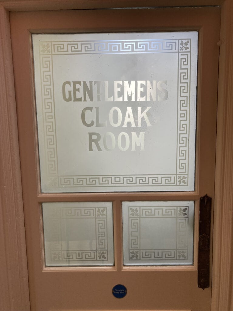 Acid etched 'Gentlemens Cloak Room' glass door with Greek key border, Royal Hall, Harrogate