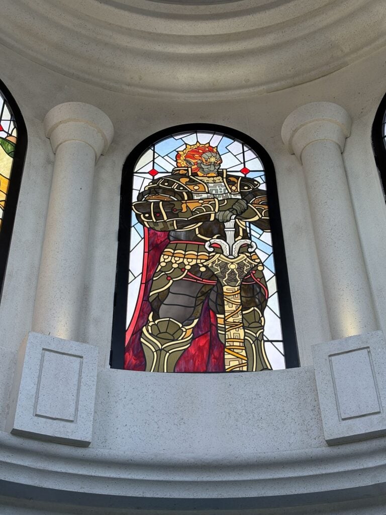 Arched dome window with armoured figure and red cape