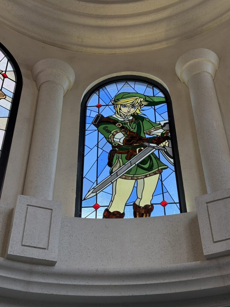 Arched dome window with swordsman in green tunic