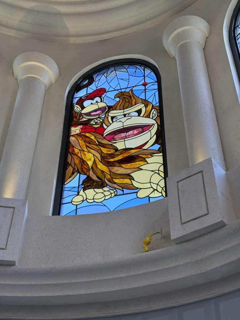 Arched dome window with two gorilla characters