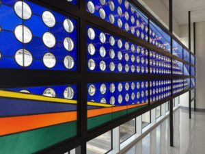 Blue glass wall with roundels wide view