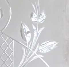 Close-up of brilliant cut glass with a cut leaf and diamond lattice pattern