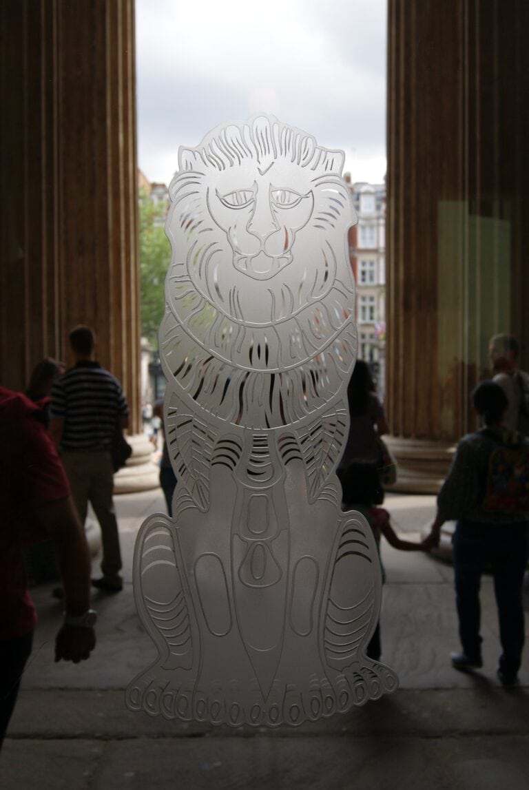 Carved lion in glass between stone columns