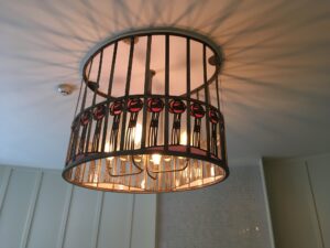 Ceiling light with red glass roundels in a drum cage