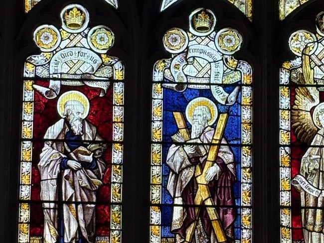 Detail of two standing figures in a Victorian church stained glass window
