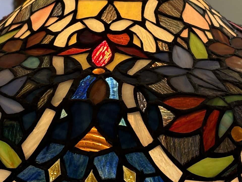 Floral panels of a copper foil stained glass lamp in opalescent glass