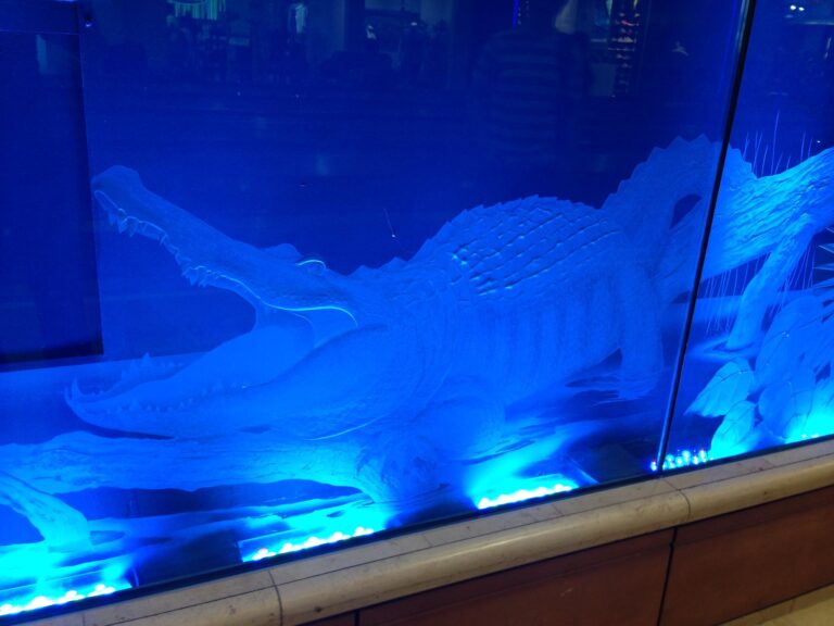 Deep carved alligator panel lit in blue