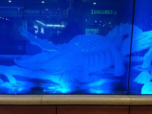 Deep carved alligator panel lit in blue wider view