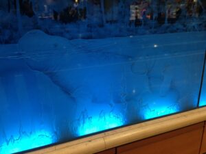 Deep carved animal panel lit in blue
