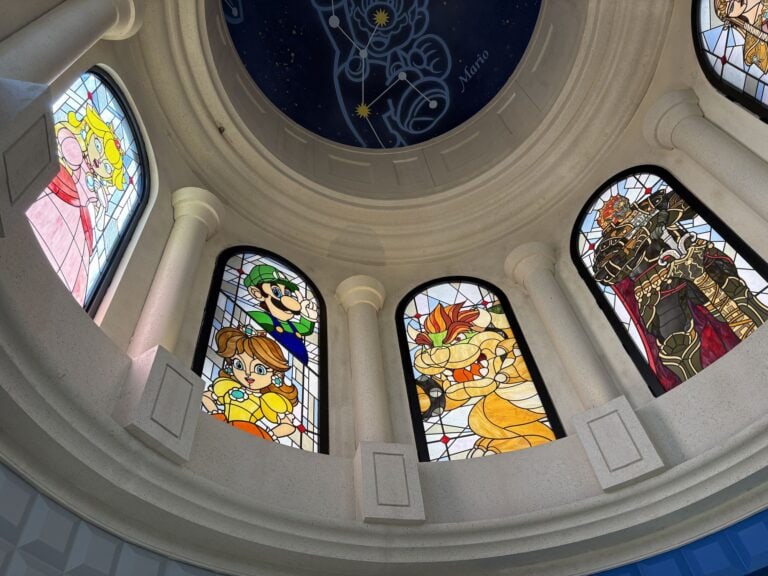 Domed room with tall arched stained glass windows each showing a cartoon character