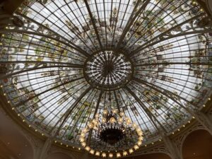 Domed stained glass ceiling with chandelier wide view