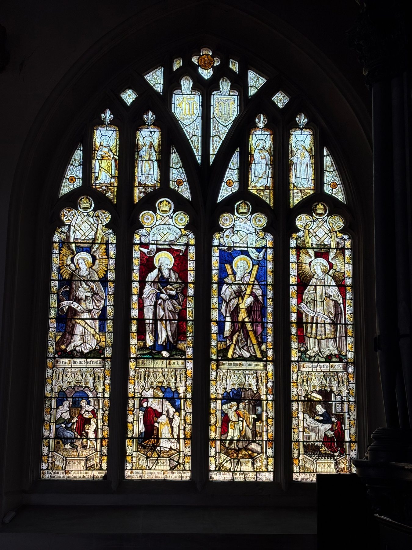 Four-light church window with saints in coloured stained glass