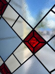 Pair of arched door windows in clear leaded diamond quarries with red faceted jewels - second view