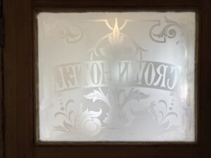 Etched glass panel in a door seen from the reverse