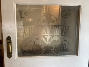 Etched glass panel in a white door with fleur de lis