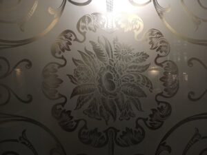 Etched glass panel with large leafy flower centre
