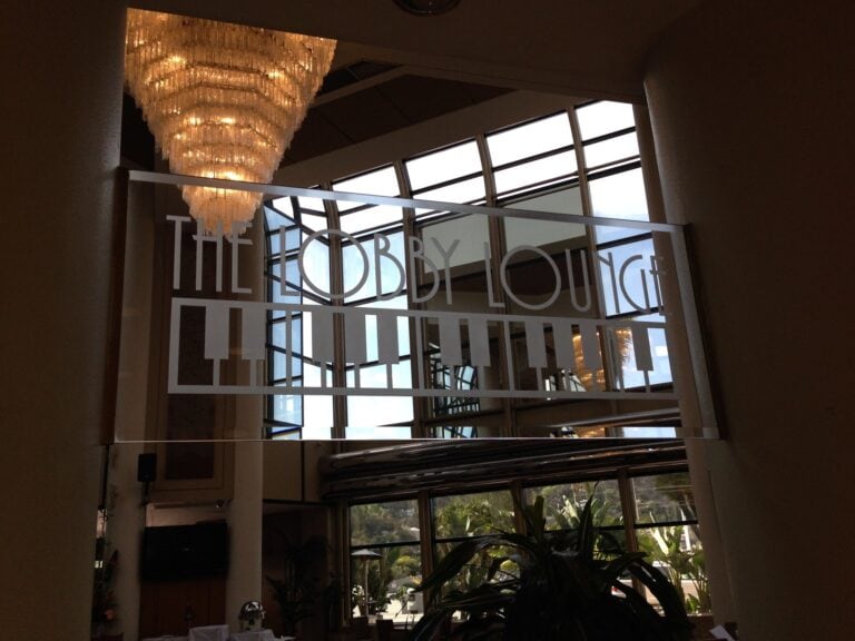 Etched lettering sign above a lounge entrance