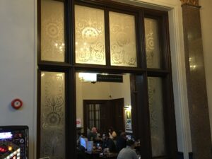 Etched window panels above and beside a timber doorway