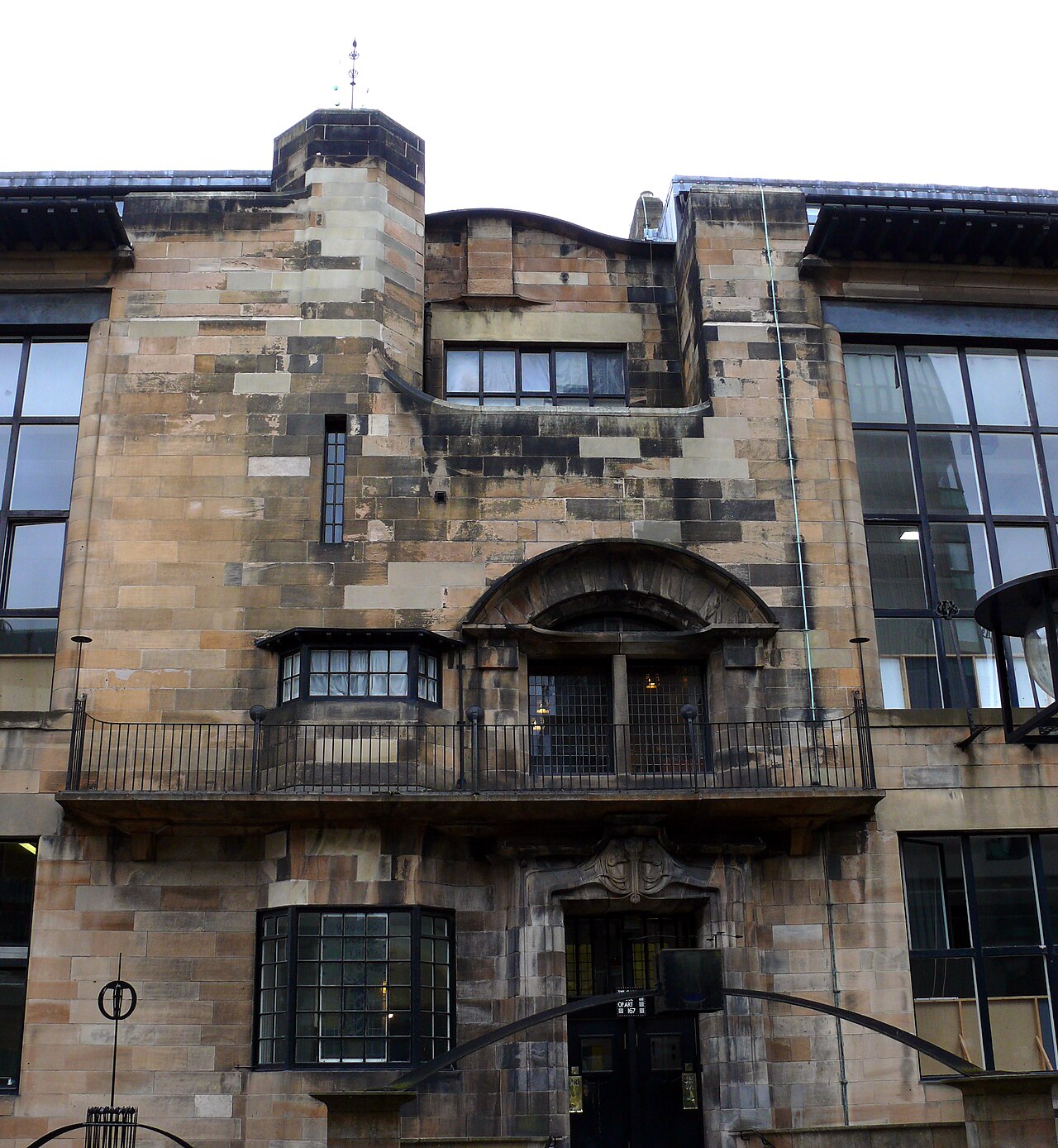 Front of the Mackintosh Building at the Glasgow School of Art, with its tall studio windows and stone entrance