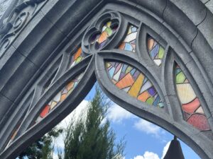 Gothic arch tracery coloured glass close up 2