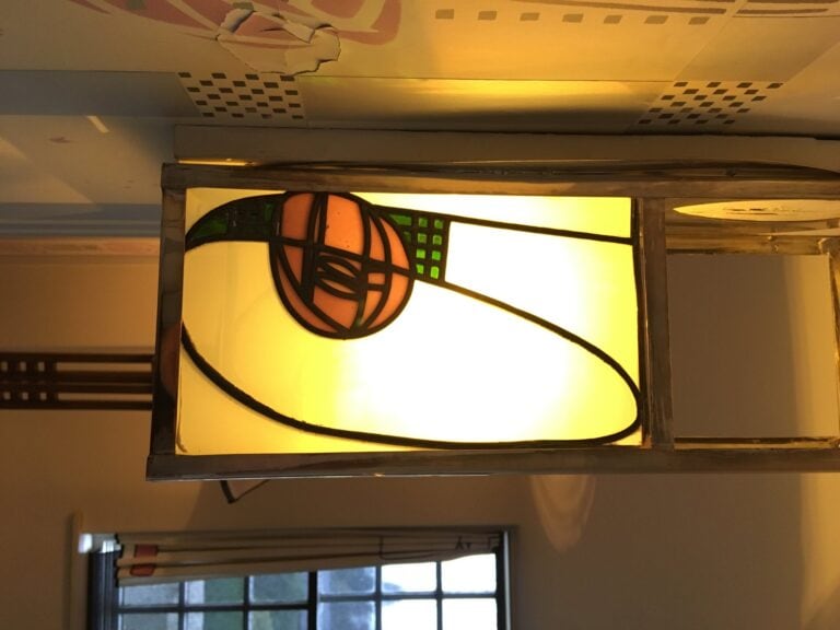 Ceiling light with a rose motif in coloured glass at Hill House