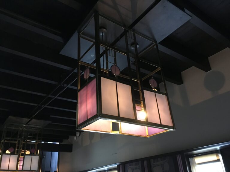 Hanging light with pink and white leaded glass in the hall at Hill House