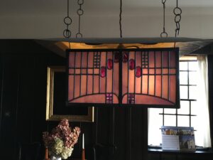 Hanging light with rose motifs in pink and clear leaded glass at Hill House