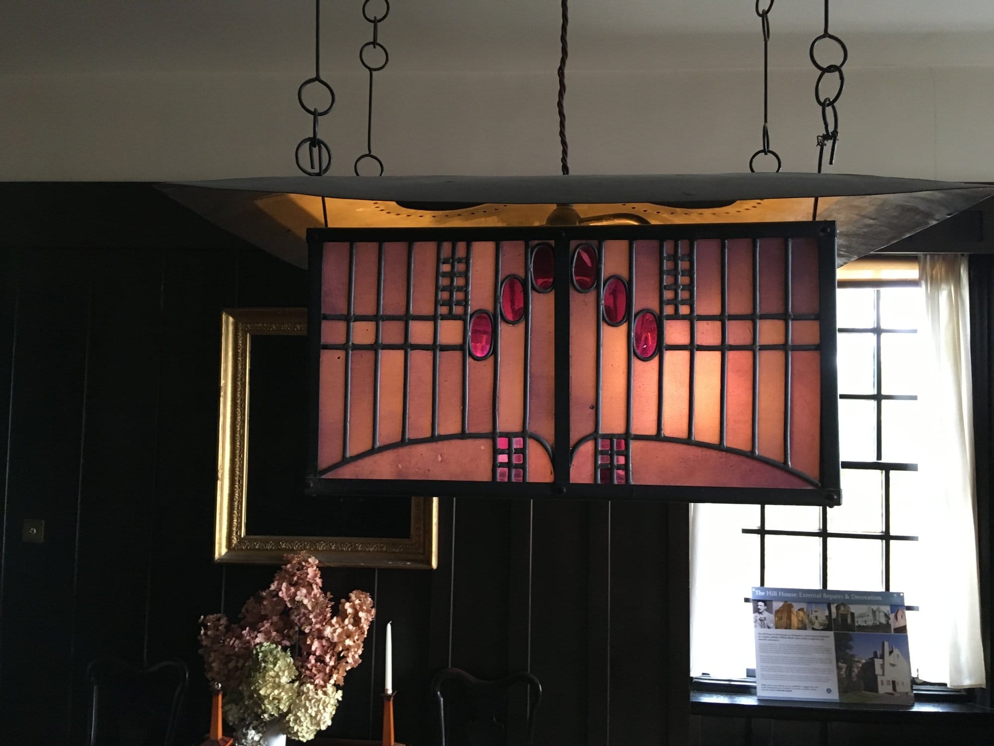 Hanging light with rose motifs in pink and clear leaded glass at Hill House