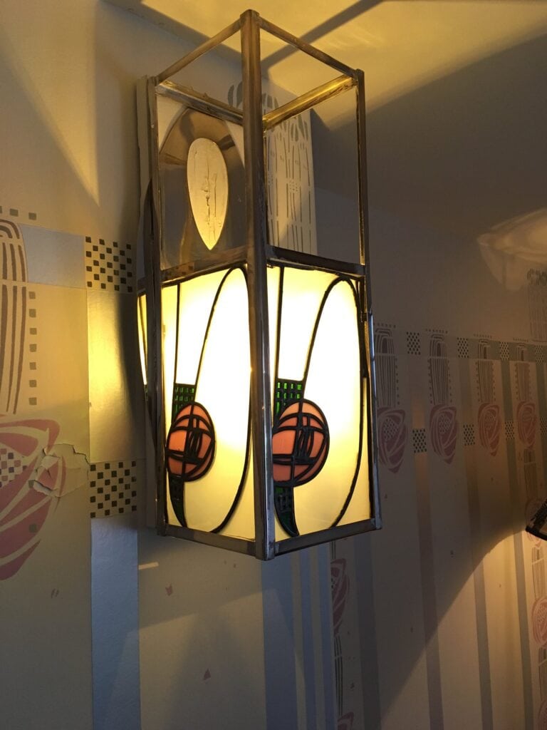 Wall lantern with pink and green rose motifs in leaded glass at Hill House
