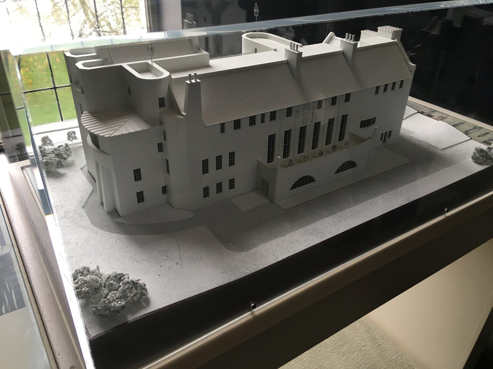 An architectural model of House for an Art Lover under a glass case
