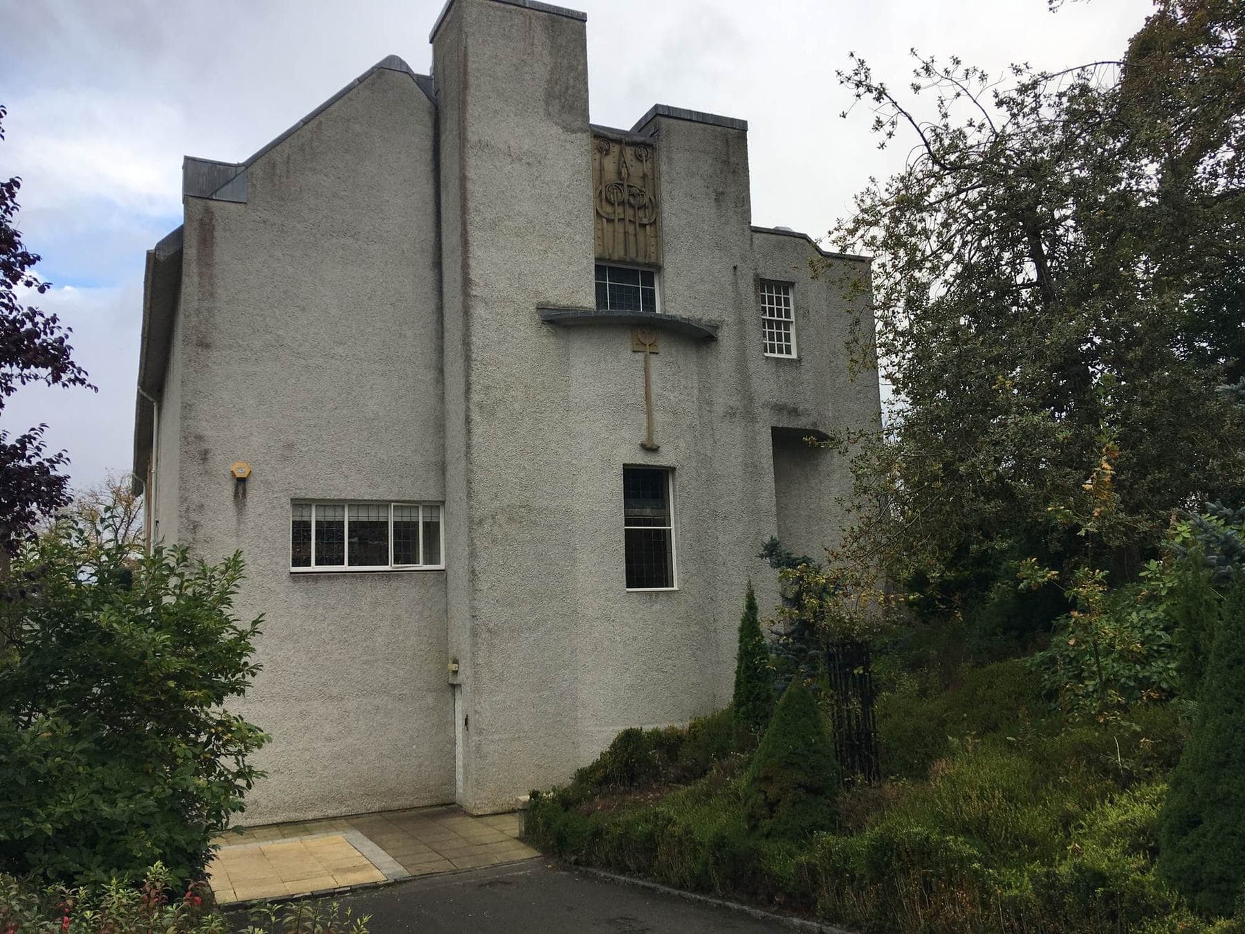 The east end and gable of House for an Art Lover seen through trees