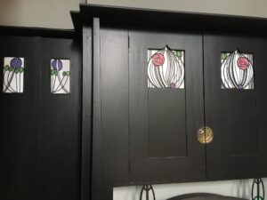 Panelled doors with rose motifs in leaded glass at House for an Art Lover