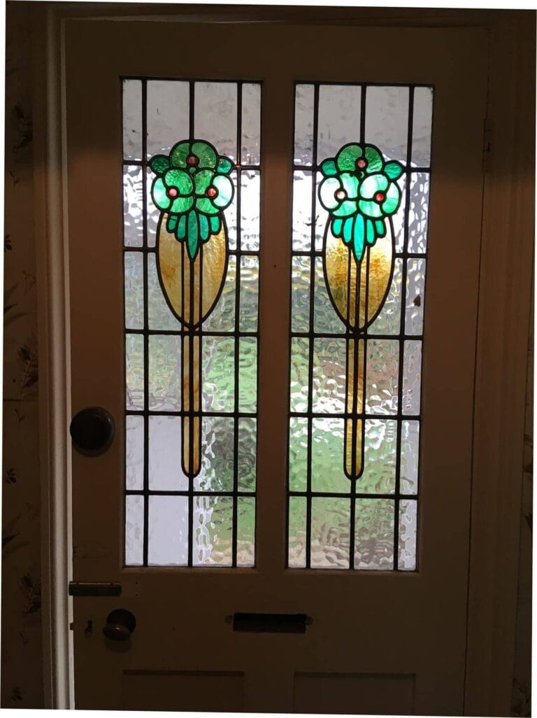 Two leaded light door panels with amber and green flower sprays in textured clear glass