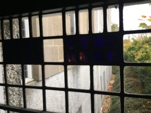 Leaded window grid with dark blue panes close up