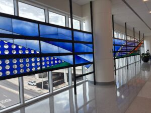 The glass wall seen along the concourse