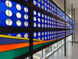 Close view of blue glass with clear roundels and bands of colour