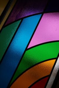 Close view of bright bands of colour in overlay stained glass