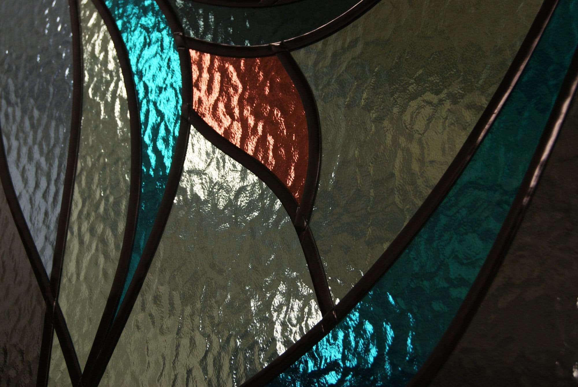 Close view of lead lines and textured glass in overlay stained glass