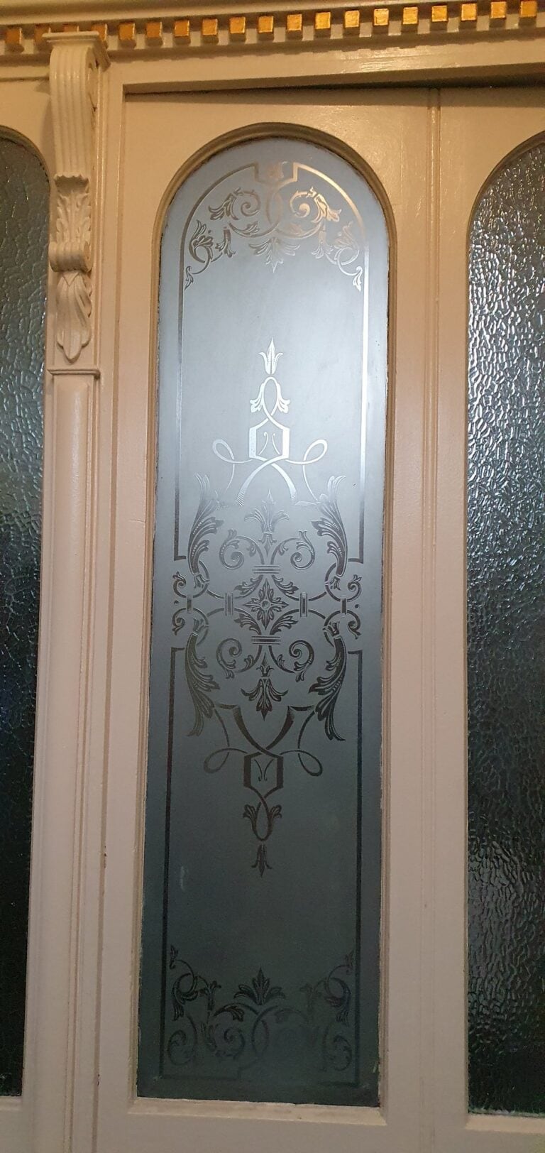 Pair of arched doors with etched glass panels