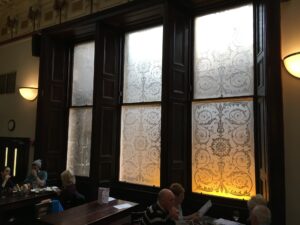 Pair of etched sash windows with scrolling patterns