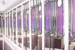 Row of purple leaded window panels along a wall