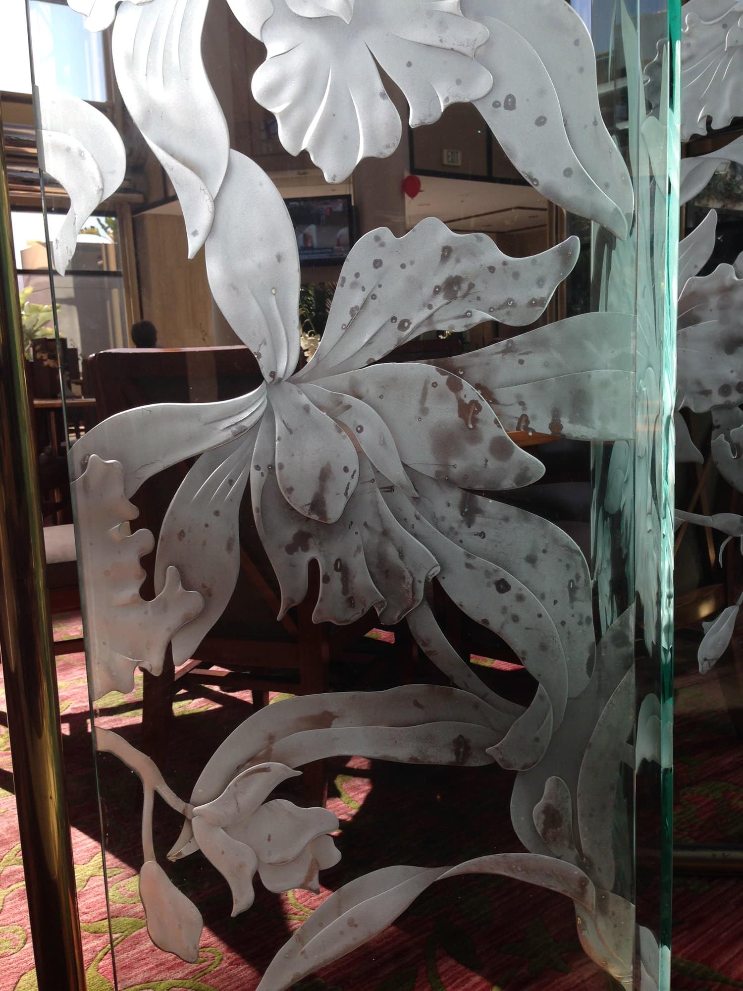Deeply carved sandblasted glass panel with an orchid flower and leaves