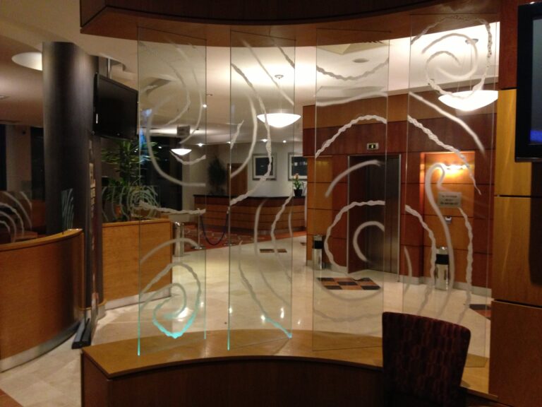 Hotel lobby glass partition sandblasted with swirling patterns