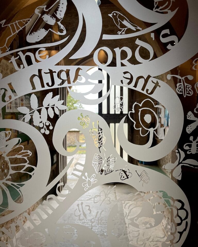 Close view of sandblasted lettering with birds and flowers