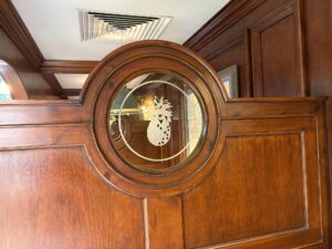 Closer view of a pineapple roundel sandblasted into a round window in a wood panelled door