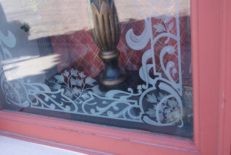 Shop window with etched scrolled corner border