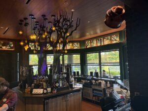 Stained glass panels above a bar beneath hanging lights