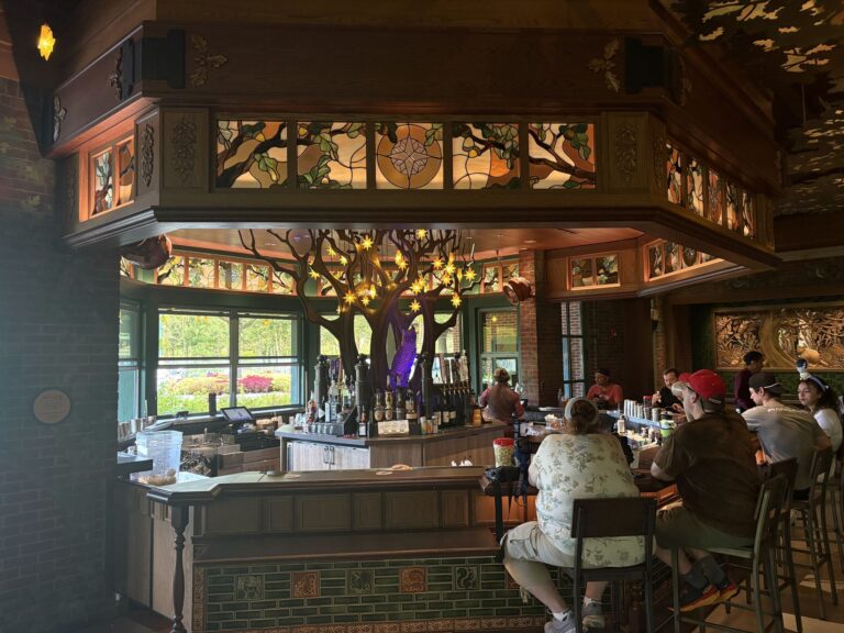 Stained glass panels in wooden frames above a circular bar