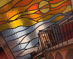Suspension bridge panel close up with sun and towers