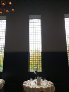 Tall narrow leaded windows in a dining room